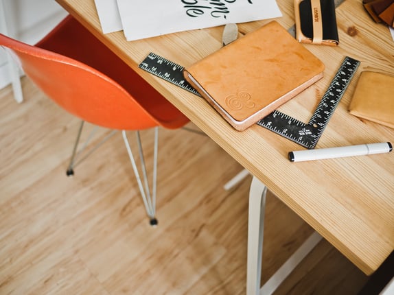 An office workbench with notebook and tools representing bespoke website design
