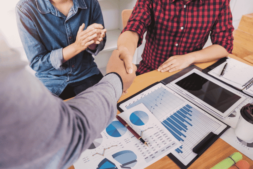 Finishing up a meeting, handshake of two happy business people after contract agreement to become a partner, collaborative teamwork-1