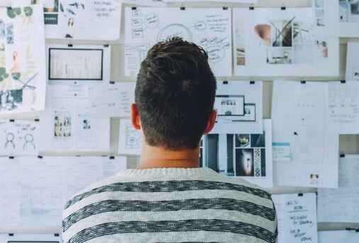 man looking a content writing strategies on a wall