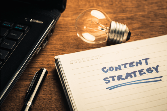 a piece of paper with content strategy written on it, visualising a b2b content marketing agency