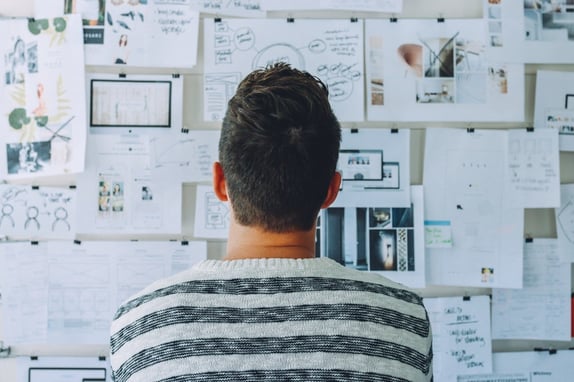 Man looking at an ideas board to represent inbound marketing gameplan