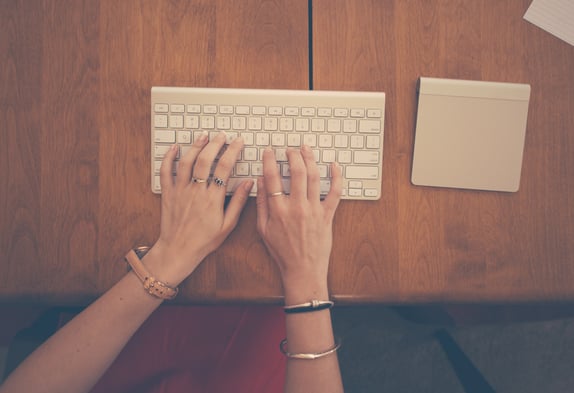 Hands on a keyword birdseye view to represent B2B content marketing strategy