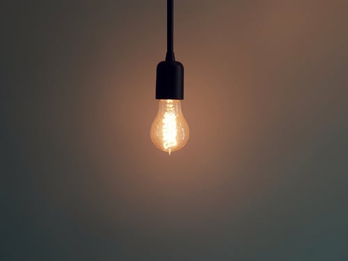 A single light bulb lighting up a dim room to represent on-page SEO strategy
