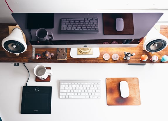 Large computer screen with keyboard, mouse and drawing tablet to represent B2B bespoke website design